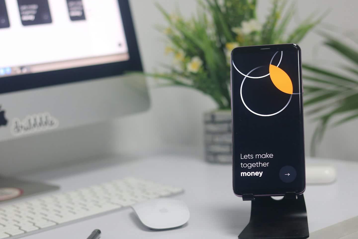 Smartphone showing app screen on a white desk.